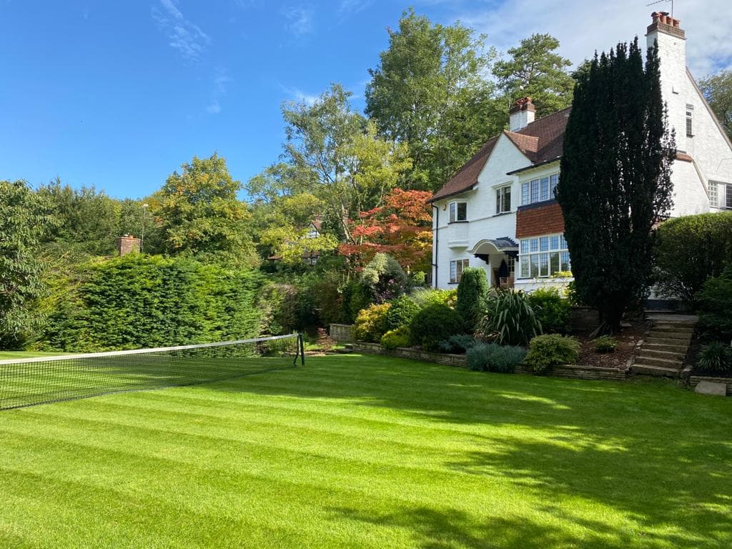 Professionally restored grass cutting result featuring high-definition lawn stripes and precision vertical edging