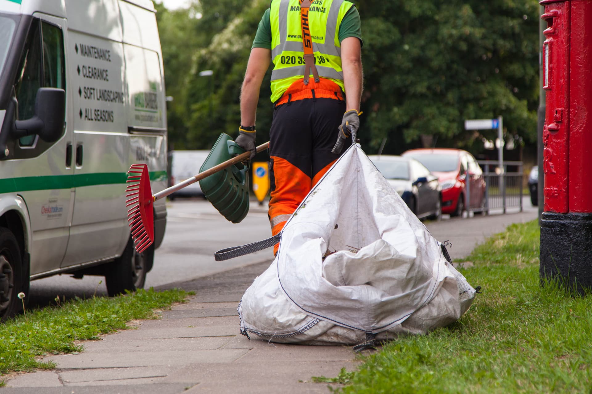 Grass Barbers professional garden clearance team removing overgrown brambles and thick ivy
