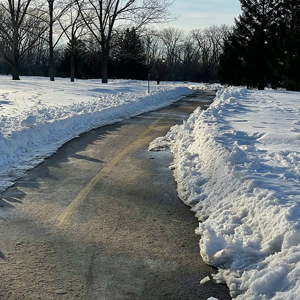 Grass Barbers professional winter maintenance process showing a safely cleared and gritted commercial pathway